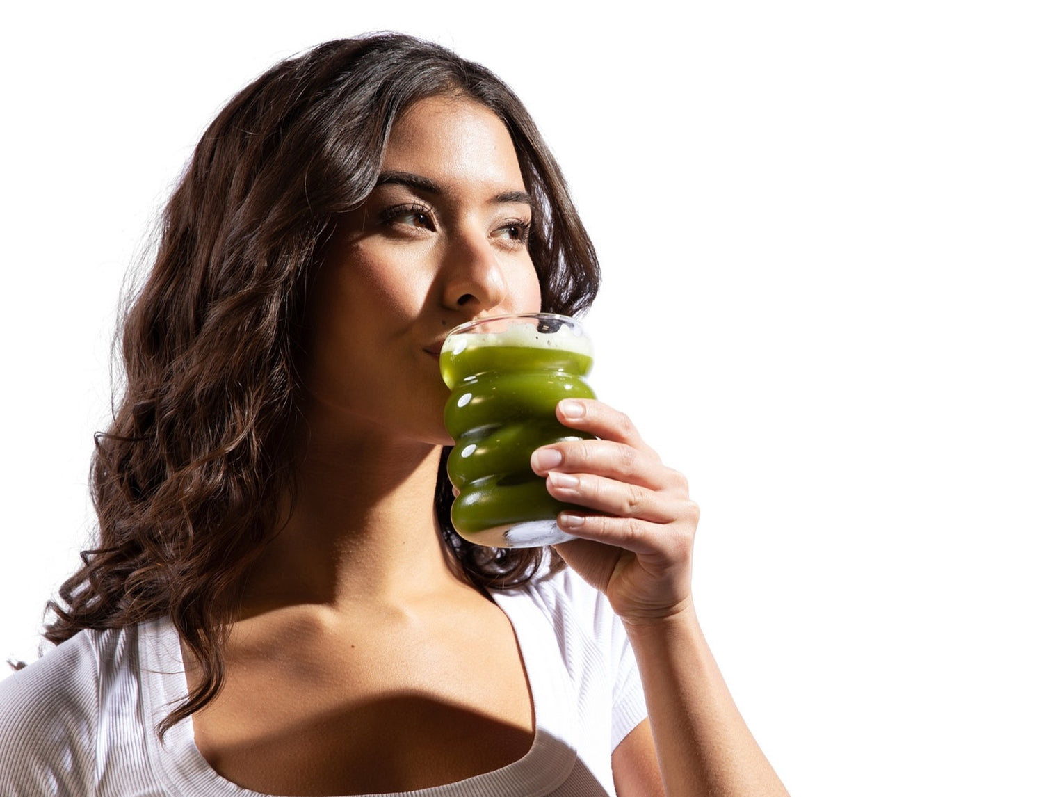 Woman drinking sencha green tea from a uniquely shaped glass